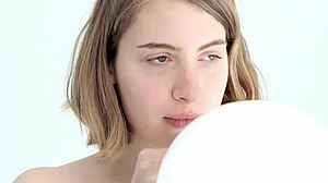 young babe subtly blows and pops her first balloon with a hint of blowjob