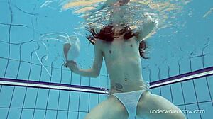 Roxalana Cheh shows off her sexy redhead body underwater, all shaved and ready.