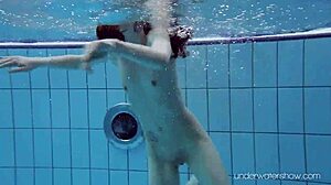 Roxalana Cheh shows off her sexy redhead body underwater, all shaved and ready.