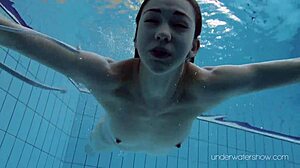 Roxalana Cheh shows off her sexy redhead body underwater, all shaved and ready.