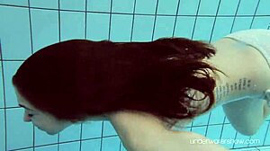 Roxalana Cheh shows off her sexy redhead body underwater, all shaved and ready.