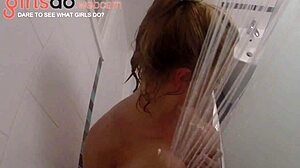 Adorable blonde teen gets horny in the shower, showing off her huge boobs on webcam
