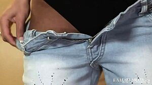 Slender coed Reagan Manx finger fucks her tight pussy on the couch.