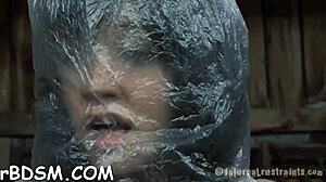 Brunette woman explores self-pleasure with a toy in a private moment.