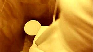 Couple caught in intimate moment in public restroom.