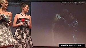 Female and male strippers tease the audience