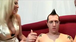 Clothed females give handjob to naked male