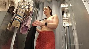 Trying on clothes with open curtain in fitting room