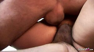 two mature women interact with two workers in the garage