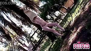 Nina shows sexy body and rubs pussy outdoors