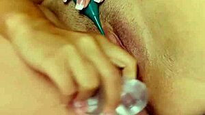 teasing shaved pussy with two dildos