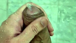 Young Brazilian guy masturbates in the shower until he cums.