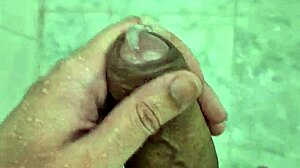 Young Brazilian guy masturbates in the shower until he cums.