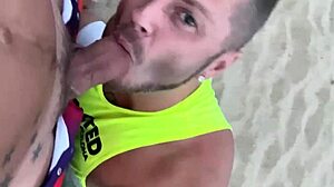 guy gives blowjob to another on public gay beach