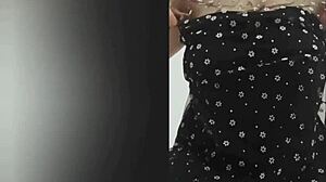 Busty beauty in black shows off big tits with stunning charm.