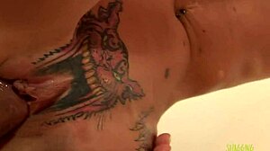 Skinny blonde with a pussy tattoo gets a creampie on a red couch