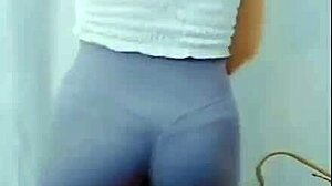 the young asian girl dances in the room, showing off her cameltoe