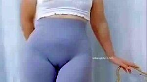 the young asian girl dances in the room, showing off her cameltoe