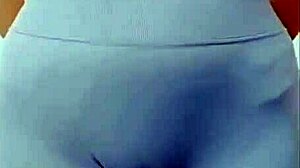 the young asian girl dances in the room, showing off her cameltoe