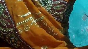 She lifts her ghunghat to touch her pussy.