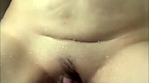 Milf masturbates wet clit in shower