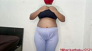 Young woman with tattoos and natural big tits enjoys solo time happily.