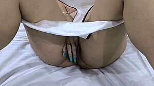 girl in boots relaxes on bed solo.