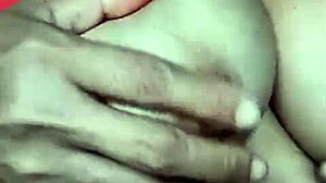 A mature wife showcases her breasts in an intimate, sensual scene