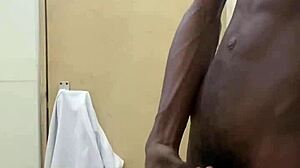 a guy busts a nut in public bathroom with huge black cock