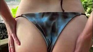 Horny teen in bikini gives oily titjob and blowjob on beach