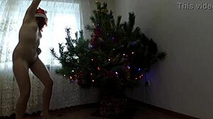 bitch dancing around the christmas tree, showing small tits and ass