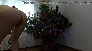 bitch dancing around the christmas tree, showing small tits and ass