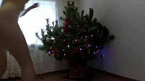 bitch dancing around the christmas tree, showing small tits and ass