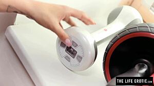 Sweaty babe fucks vibrating dumbbell at gym