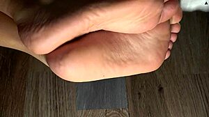 Cleaning her feet with damp cloth and showing green fingernails close-up