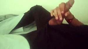 horny guy moans while jerking his huge cock in bedroom after work, cumming hard