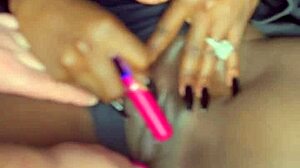 Sexy black model uses vibrator on wet shaved pussy