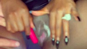 Sexy black model uses vibrator on wet shaved pussy