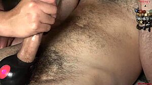 I give handjob while he vibrates scrotum for big cumshot on nails?